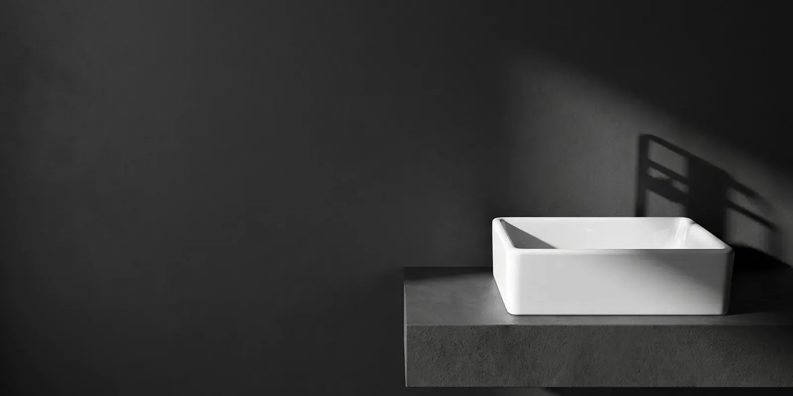Close-up view of glossy self-cleaning ceramic glaze and thick-edge profile on a rectangular countertop basin